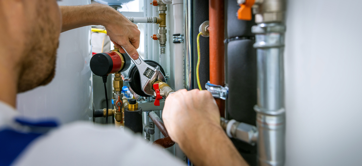 Plumber working on pipes
